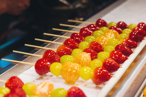 Seoul ddalgi satang Korean fruit hard candy on stick skewers candied strawberry grape and tangerine in hardened sugar traditional street food Seoul South Korea AdobeStock 1992534988 web
